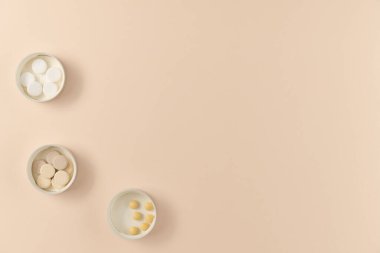 Bej arka planda üç çeşit hap var. Düz yerde, üst tarafta. Boşluğu kopyala