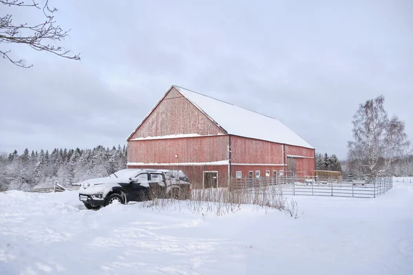 stock image Typical Swedish red painted agricultural building in Bredebolet in Skaraborg in Vaestra Goetaland in Sweden in winter