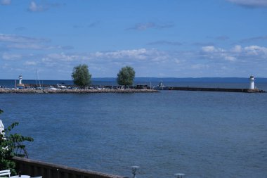 Impressions from the wooden town of Hjo at Lake Vaettern in Skaraborg Sweden on a sunny summer day clipart