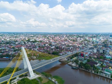 Aerial drone view of Siak Bridge IV (Abdul Jalil Alamuddin Syah Bridge) above Siak River (Sungai Siak) in Pekanbaru, Riau, Indonesia clipart
