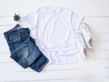 White T Shirt mockup weathered, canvas shoes and Jeans on white wood background shirt templat