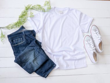 White T Shirt mockup weathered, canvas shoes and Jeans on white wood background shirt templat