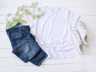 White T Shirt mockup weathered, canvas shoes and Jeans on white wood background shirt templat