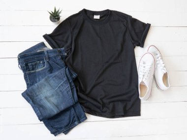 Black T Shirt mockup weathered, canvas shoes and Jeans on white wood background shirt template