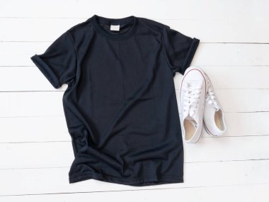 Black T Shirt mockup weathered and canvas shoes on white wood background shirt template