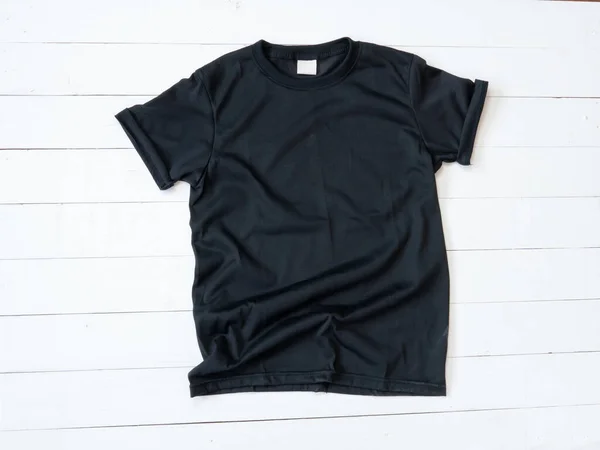 Black T Shirt mockup on white wood background shirt templat