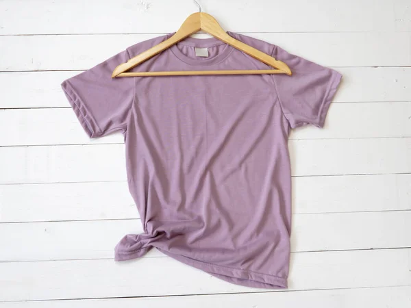Purple T Shirt mockup and hanger on white wood background shirt templat