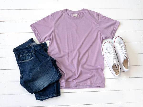 Purple T Shirt mockup weathered, canvas shoes and Jeans on white wood background shirt templat