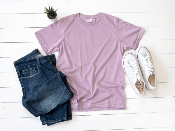 Purple T Shirt mockup weathered, canvas shoes and Jeans on white wood background shirt template