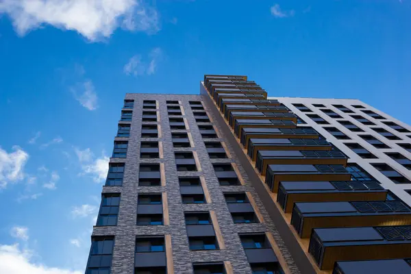 stock image modern multistory building with blue sky and clouds background.