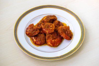 Tasty Bengali food shrimp fish curry or chingri bhuna served on a white plate. Chingri vuna or prawn curry is a Bangladeshi-style dish with spicy gravy. clipart