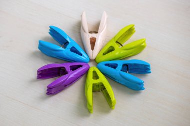 Ahşap bir arka planda güzel ve renkli mandallar veya elbise klipsleri.