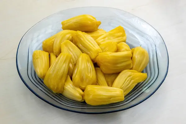 stock image Delicious jackfruit on a glass plate on wooden background. Jakfruit is a healthy tropical fruit.