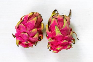 Two dragon fruit on white background. Top view. clipart