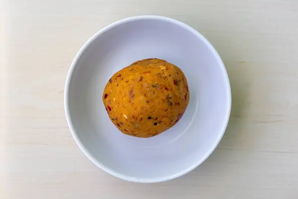 stock image Delicious kathaler bichi bharta in a white bowl on wooden background. Jackfruit seed bhorta is a very tasty and nutritious Bengali dish. Top view.