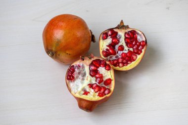 Hafif ahşap bir yüzeyde bir buçuk nar..