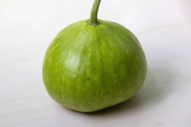 A fresh, green round gourd, also known as calabash, freshly harvested from the farm. clipart