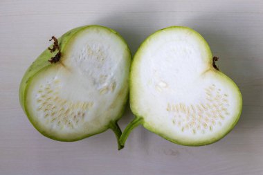 Fresh green round gourd calabash, sliced in half. Top view. clipart