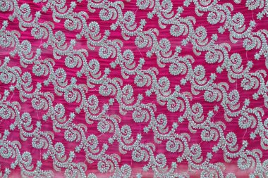 Koyu pembe Georgette kumaş desenli, boncuk işlemeli çiçek deseni. Zarif tekstil arkaplanı.