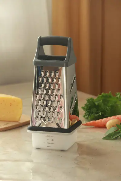modern grater on table in kitchen