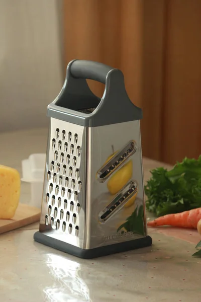 metal grater on table in kitchen