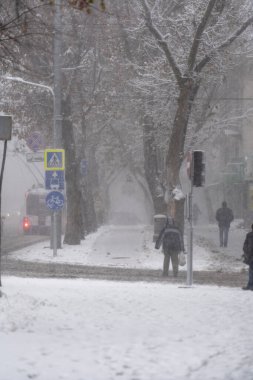 City street under the snow during snow blizzard in winter