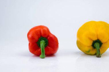 Two bell peppers isolated on white background. Bell peppers of various colors on a white background. clipart