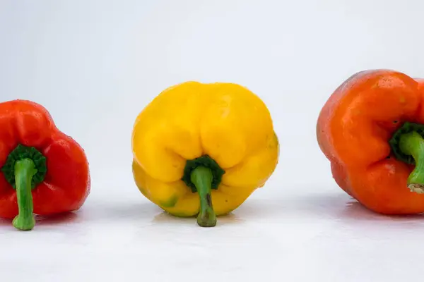 Three bell peppers isolated on white background. Bell peppers of various colors on a white background.