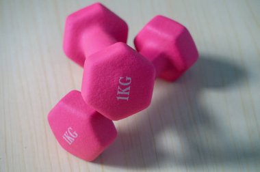Two pink 1kg dumbbells. Weights for a fitness training. clipart