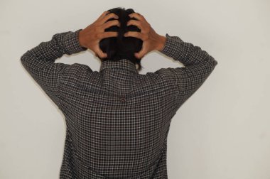 Stres jesti yapan genç bir adamın başını tutuşu. beyaz arkaplanda izole edilmiş 