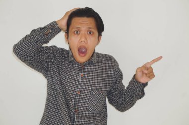 Siyah tişörtlü genç Asyalı bir adam elini yana uzatarak şaşırdı.