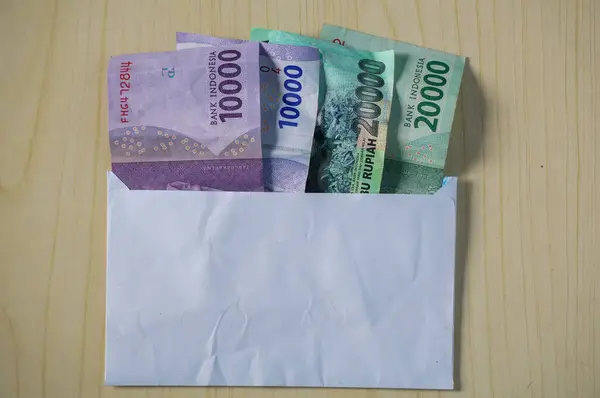 Rupiah money on a white envelope. THR on Eid al-Fitr or Eid days