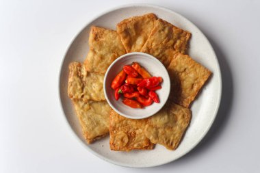 Fried tempeh served with red chili peppers, one of popular street food from Indonesia. clipart