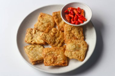 Fried tempeh served with red chili peppers, one of popular street food from Indonesia. clipart