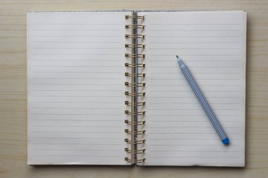 Boş bir defter ya da tahta bir masa üzerindeki kalem ile yüzük klasörünü aç