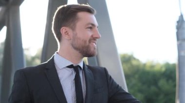 Gülümseyen bir ofis çalışanı sabahın köründe kahve içerken mutlu bir iş adamı portresi başka tarafa bakıyor. Yavaş çekim