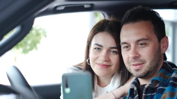 一对恋人在一辆新买的车上拍了一张自拍的照片 买一辆电动车 4K视频 — 图库视频影像