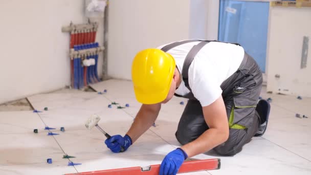 Construction Worker Overalls Sitting Checks Quality Level Flat Floor Tiles — Stock Video
