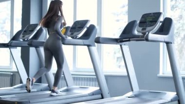 Çekici genç sporcu kadın spor salonunda antrenman yapıyor. Koşu bandında kardiyo eğitimi alıyor. Koşu bandında koşmak.
