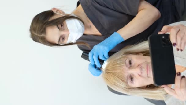 専門のトリコロジストによる毛髪検査 美容室でのヘアトリートメント 医者の予約で老婦人 — ストック動画