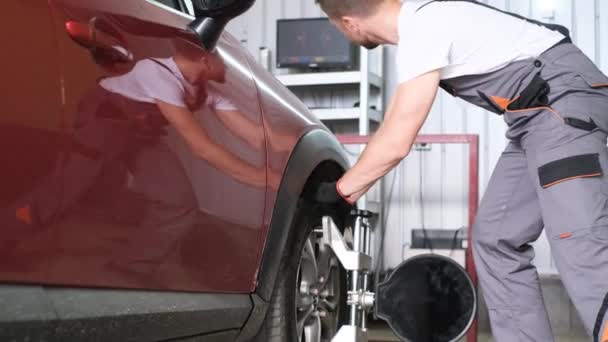 Car Wheels Alignment Equipment Stand Repair Station Auto Mechanic Adjusts — Stock Video