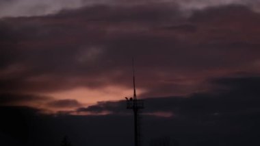 Telecommunications antenna. Silhouette antennas on sunset time.