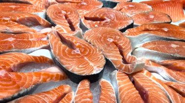 Fresh trout fish in the US market. Red fish are sold in the shop window. Delicious and healthy seafood. Slow motion