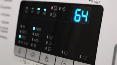 Close-up of the washing machine display. Detail of the washing machine display during washing. A working washing machine. 4k video