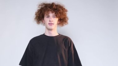 Redhead curly haired teenager showing thumbs up. Class hand gesture. 4k video