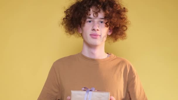 Red Haired Handsome Man Holding Gift Wrapped Yellow Paper Tied — Stock video