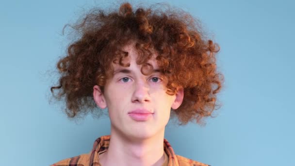 Sad Teenager Blue Background Has Red Curly Hair Boy Tired — Vídeos de Stock
