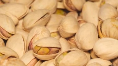 Macro video of pistachio nuts in shell rotating. Concept of healthy eating and raw food. Vegan food
