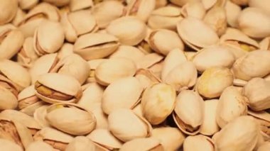 Fresh roasted pistachio nuts rotating. Healthy nutrition with nuts. Background with food.