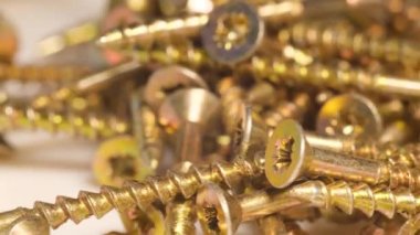 Close-up shot of metal screws. Screws on the table. background of industry. 4k video.